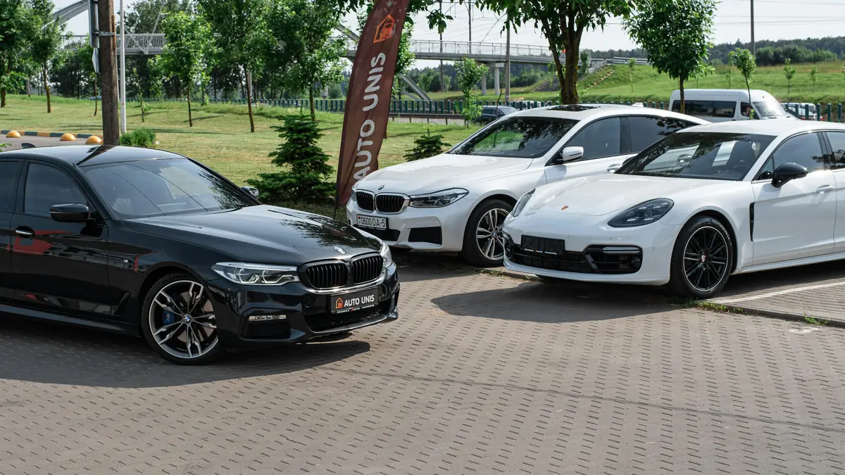 Nekoliko automobila na popločenom parkiralištu